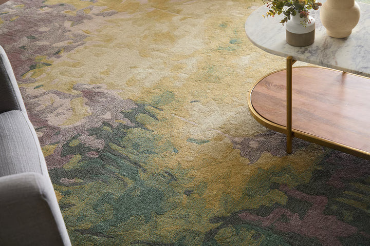 Multicolored patterned rug with a wooden side table and decorative items in the background.