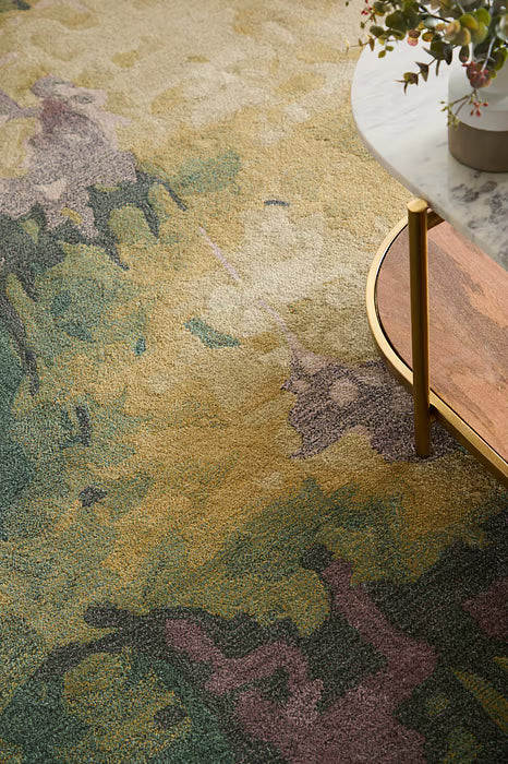 Close-up of a patterned rug with a coffee table corner in the background